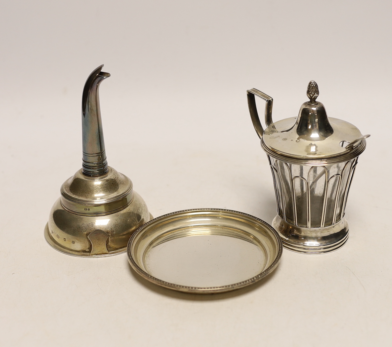 A modern silver wine funnel and stand by J.A. Campbell, 12cm and a French white metal mounted glass mustard pot, with plated spoon.